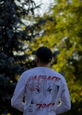 a man in a white shirt and black hat