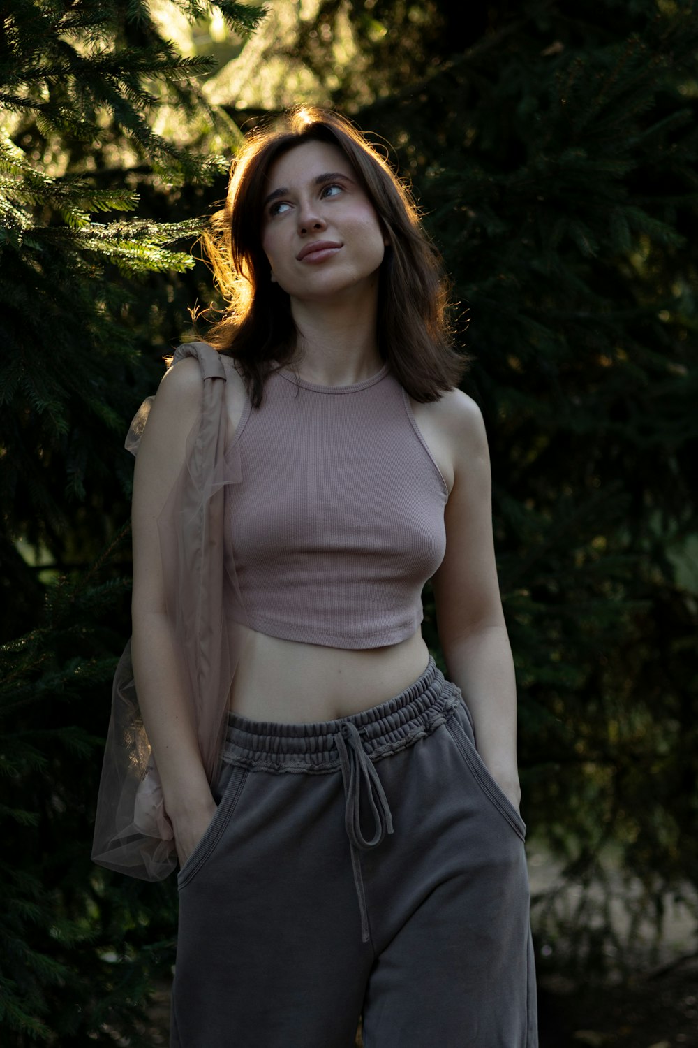 a woman standing in front of some trees