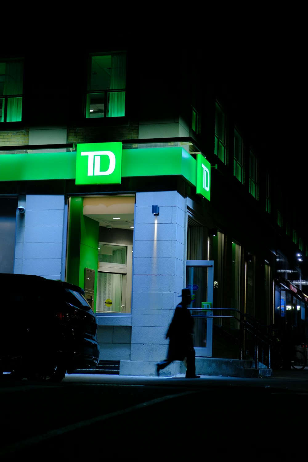 a person walking down a street at night