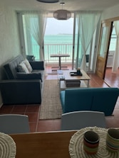 Cozy living room inside the beachfront house in Torre Lapillo with warm lighting.