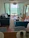 Cozy modern living room with large windows overlooking the Adriatic Sea at sunset.