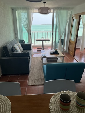 Modern apartment living room with bright natural light and sea breeze.