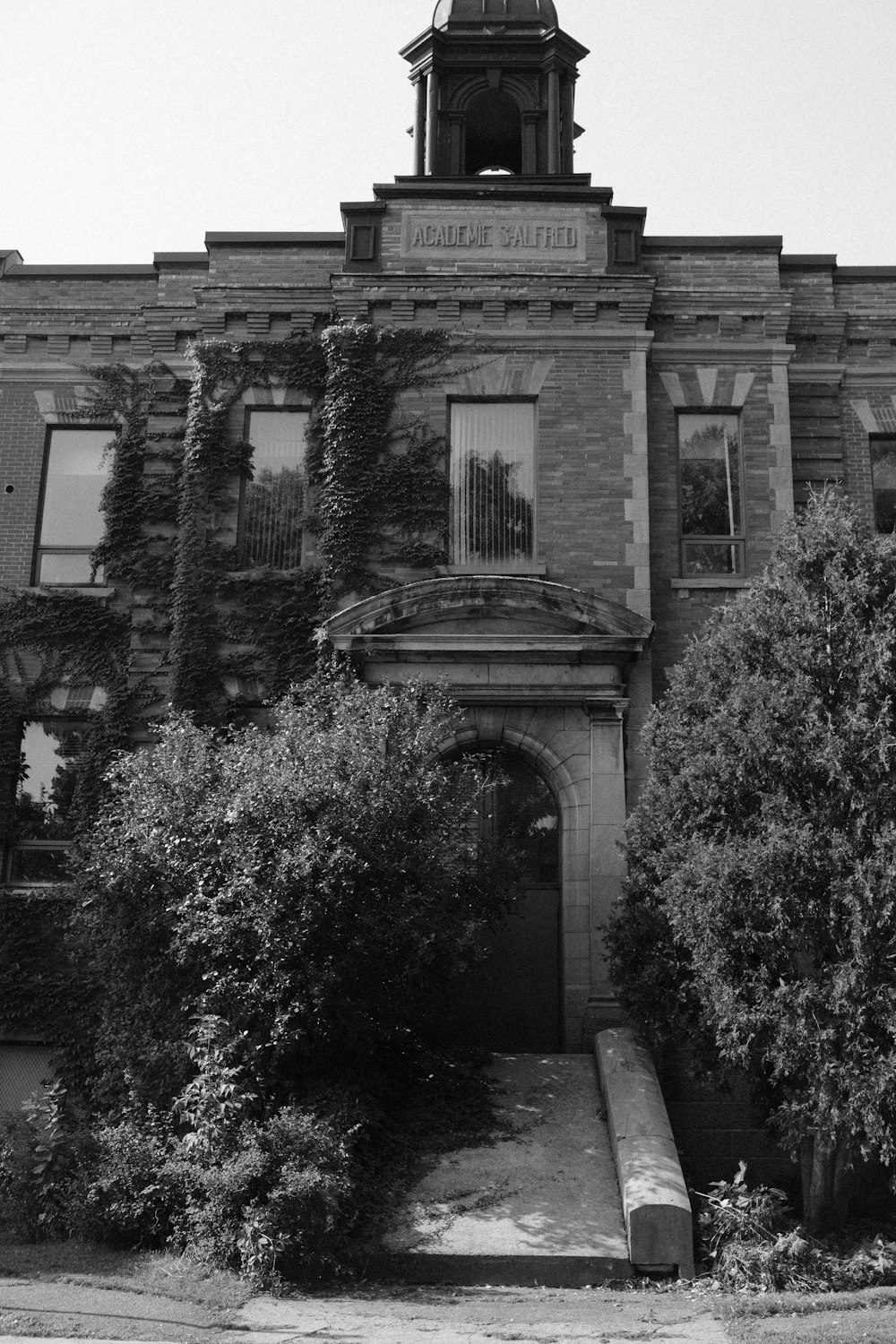 a black and white photo of a building with a clock tower