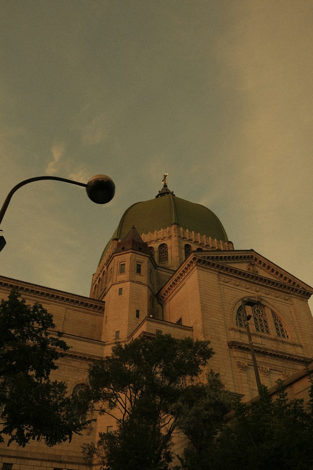 a large building with a green dome and a street light