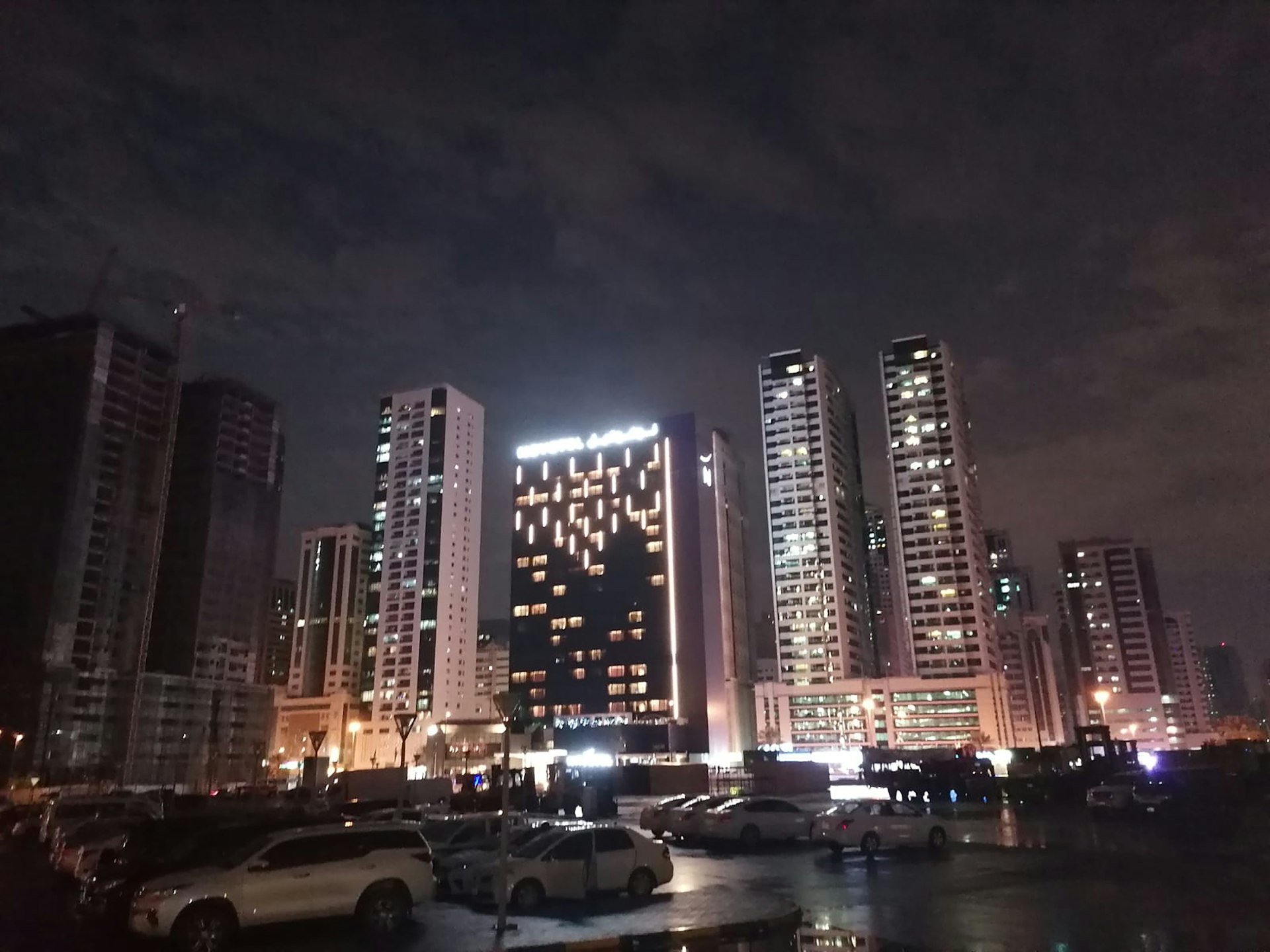 a city at night with a lot of tall buildings