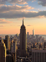 Iconic New York City skyline at sunset, blending urban energy with earthy tones.