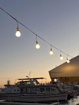 A serene harbor at sunset with a luxury cruise ship docked, inviting travelers aboard.