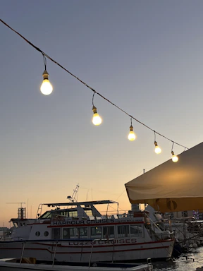 A serene harbor at sunset with a luxury cruise ship docked, inviting travelers aboard.