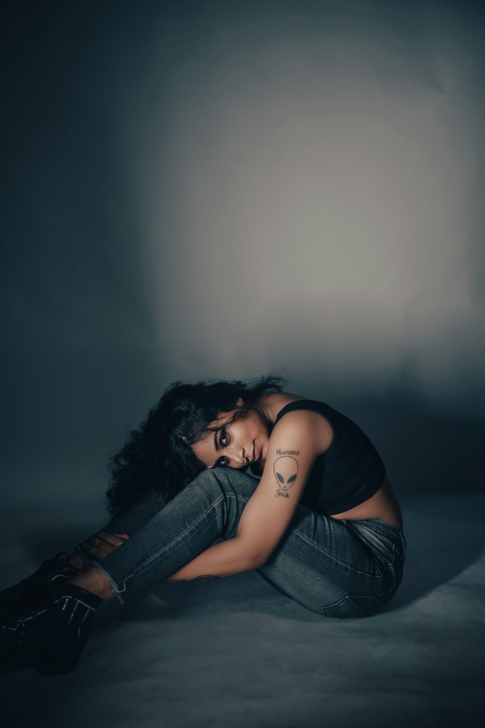 a woman sitting on the floor with her legs crossed