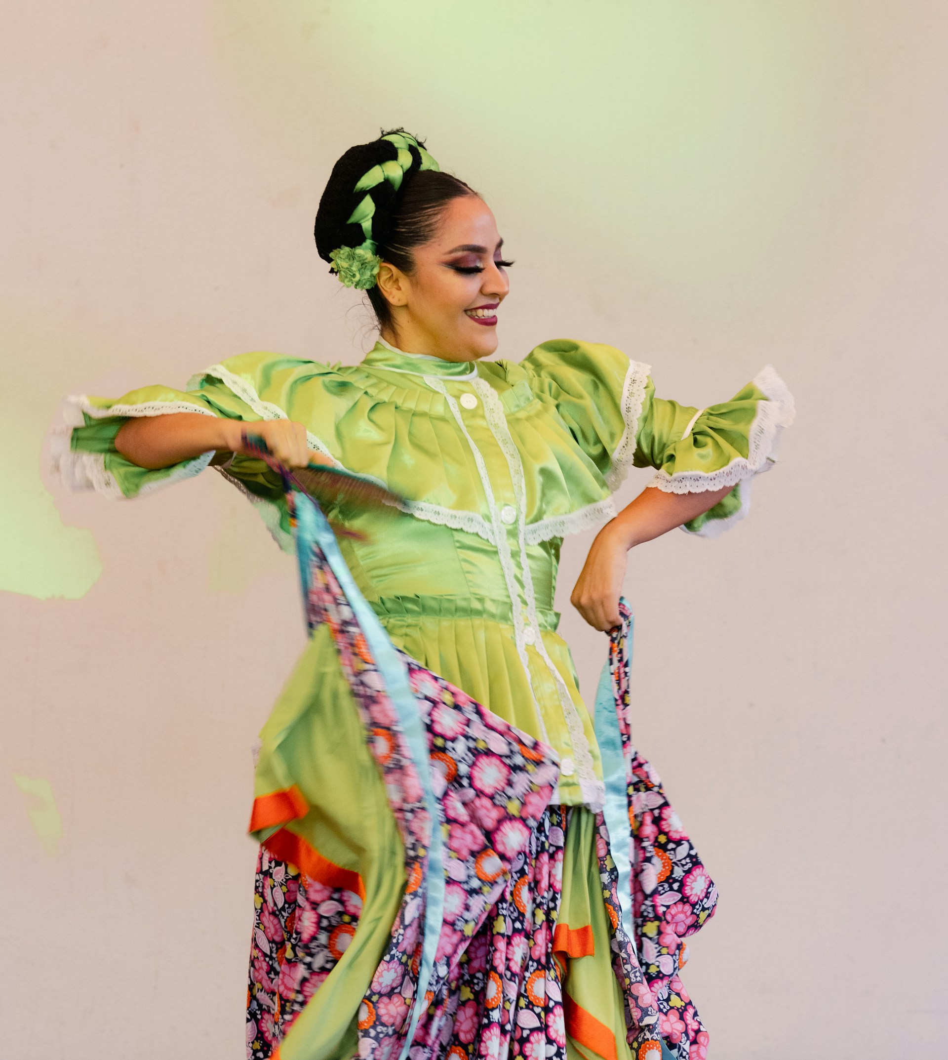 A vibrant photo capturing Veronica Morello performing a traditional dance in colorful attire, surrounded by cultural symbols.
