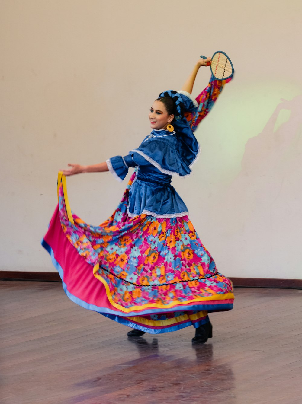 a woman in a colorful dress holding a tennis racquet