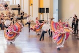 a group of people that are dancing in a room