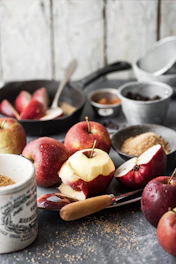 a table topped with bowls of apples and spices