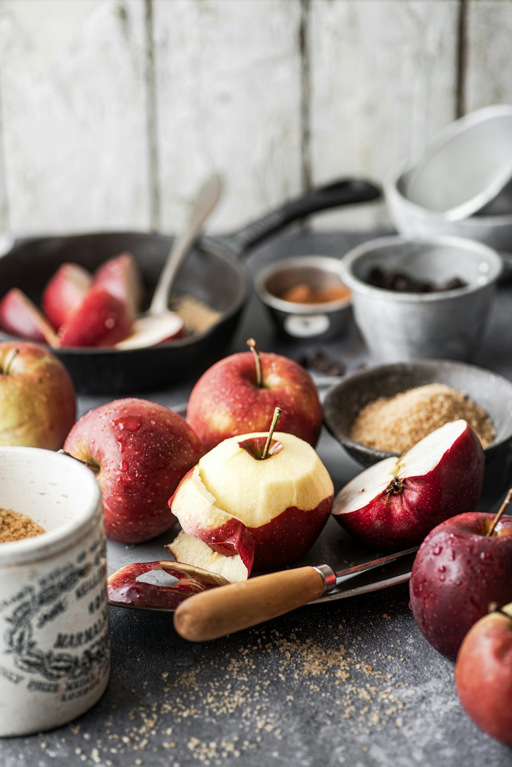 a table topped with bowls of apples and spices