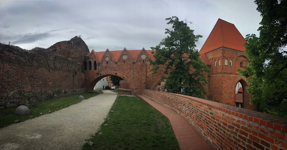 an old brick castle with a walkway leading to it