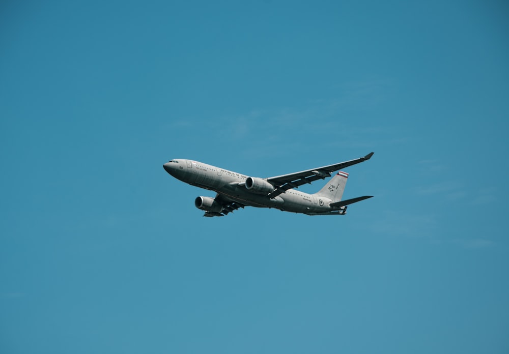 a large jetliner flying through a blue sky