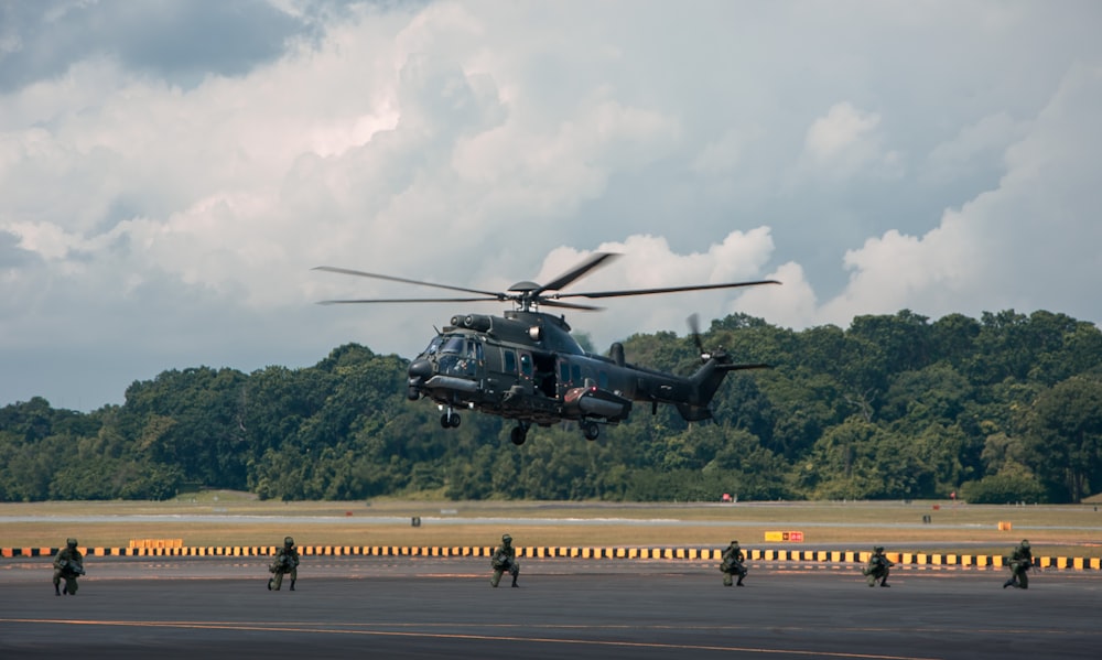 a helicopter is taking off from an airport runway