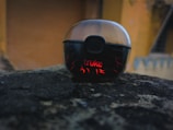 Vibetech wireless earbuds resting on a modern concrete bench with city skyline blurred in background.