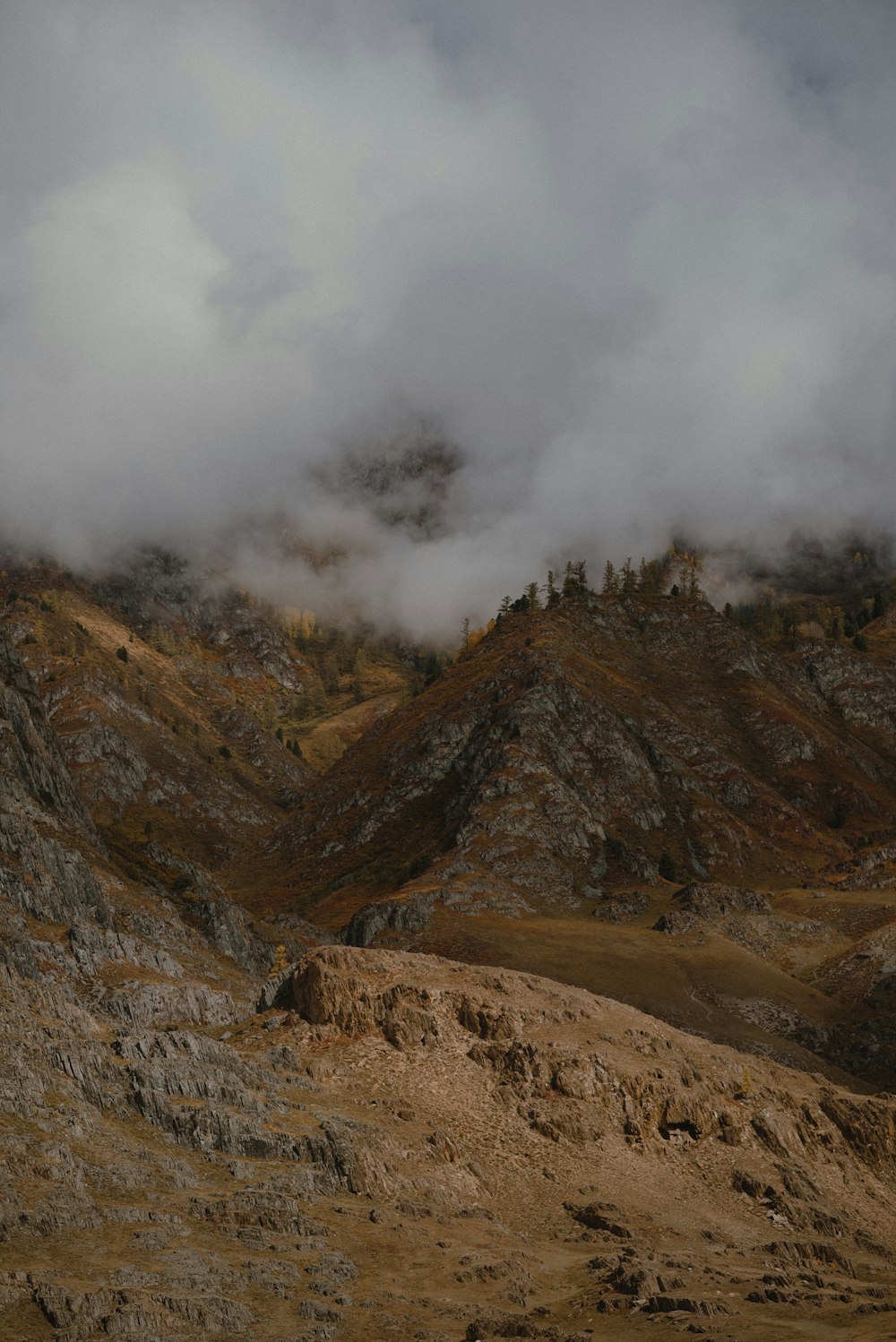 a mountain range with a few clouds in the sky