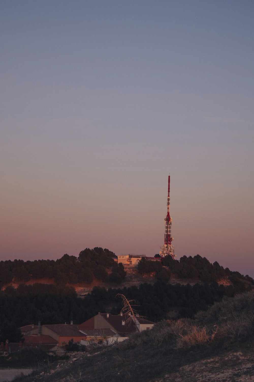 a very tall tower sitting on top of a hill