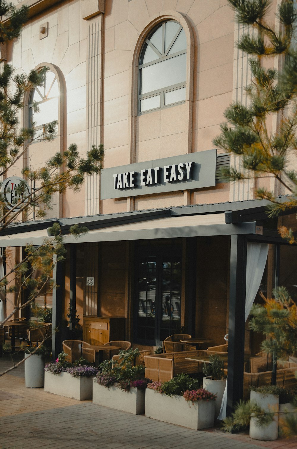 a building with a sign that says take eat easy