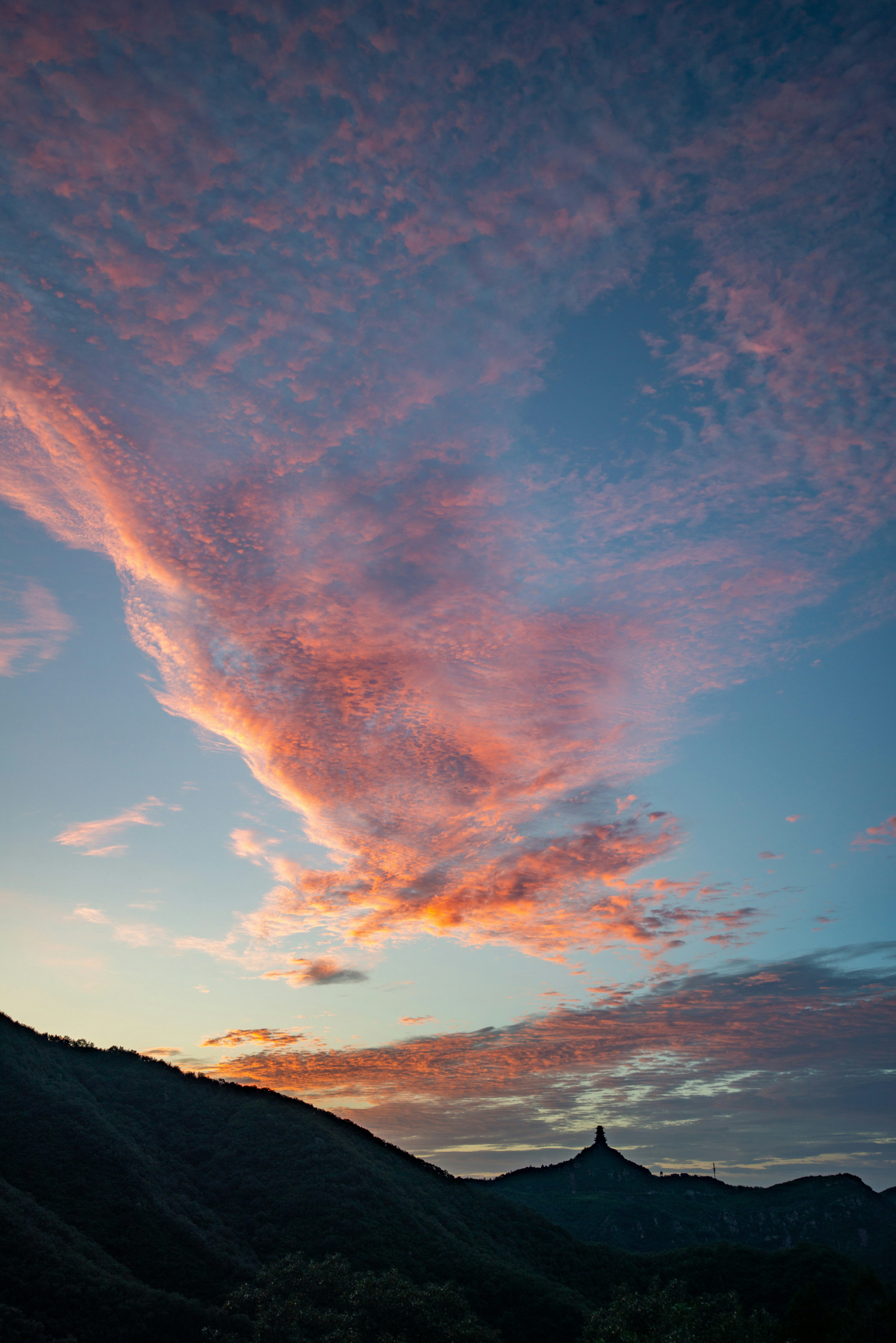a sunset with a pink cloud in the sky