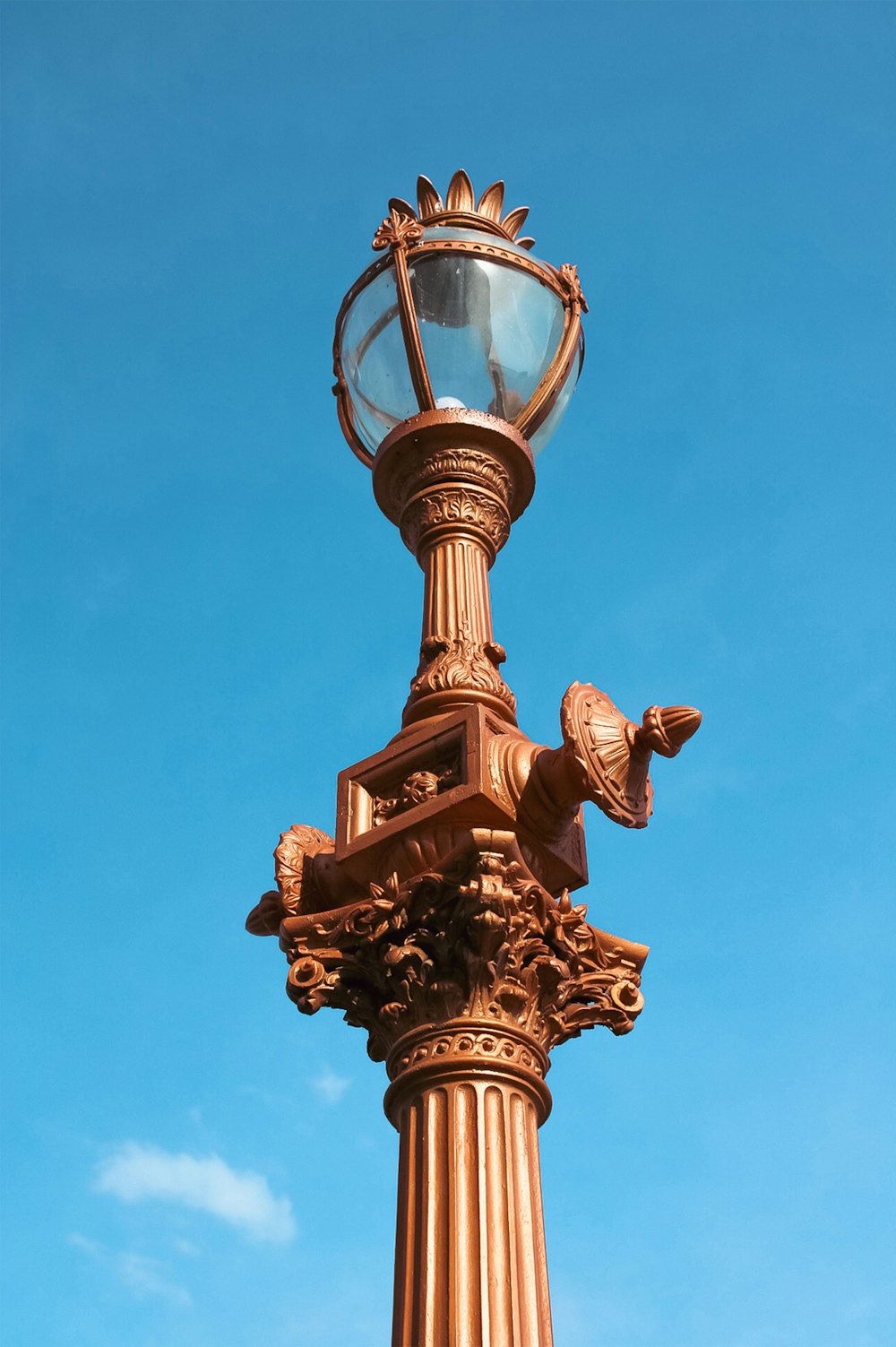 a lamp post with a bird statue on top of it