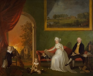 A historical painting featuring a family sitting in a room with green walls. A woman in white is seated on a red sofa, holding a veil over a child lying beside her. A man dressed in dark clothing sits on the other side, near a table with books. A young boy in dark clothing stands next to a musical instrument. A small child with a dog is on the floor in front of the sofa. In the background, there is a large window showing a landscape with trees and a building. A large painting on the wall depicts an outdoor scene.