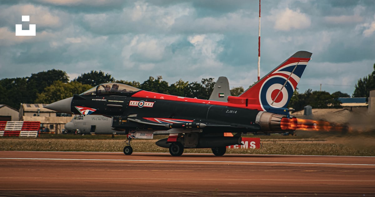 A red and black jet is on a runway photo – Free Fairford riat Image on ...