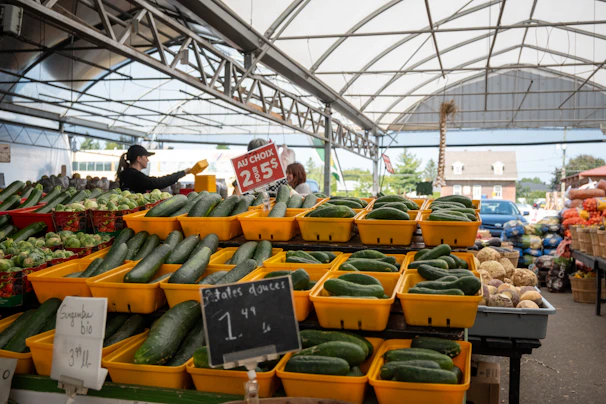 Baskets filled with crisp green zucchinis neatly arranged at the market stall.