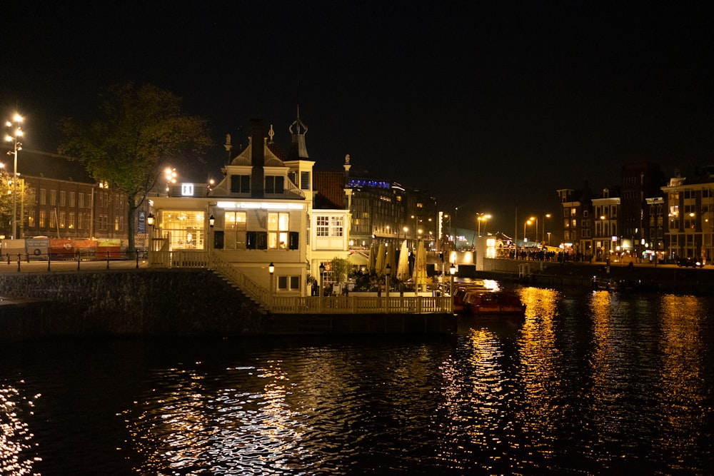 a boat is docked in a river at night