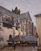 An impressionist painting depicts a large, old stone building, possibly a church or cathedral, with detailed architectural features like arches and spires. The setting appears to be a rainy day, as indicated by the wet appearance of the ground and people carrying umbrellas. A covered wooden structure sits in front, with a few figures moving around in the scene.