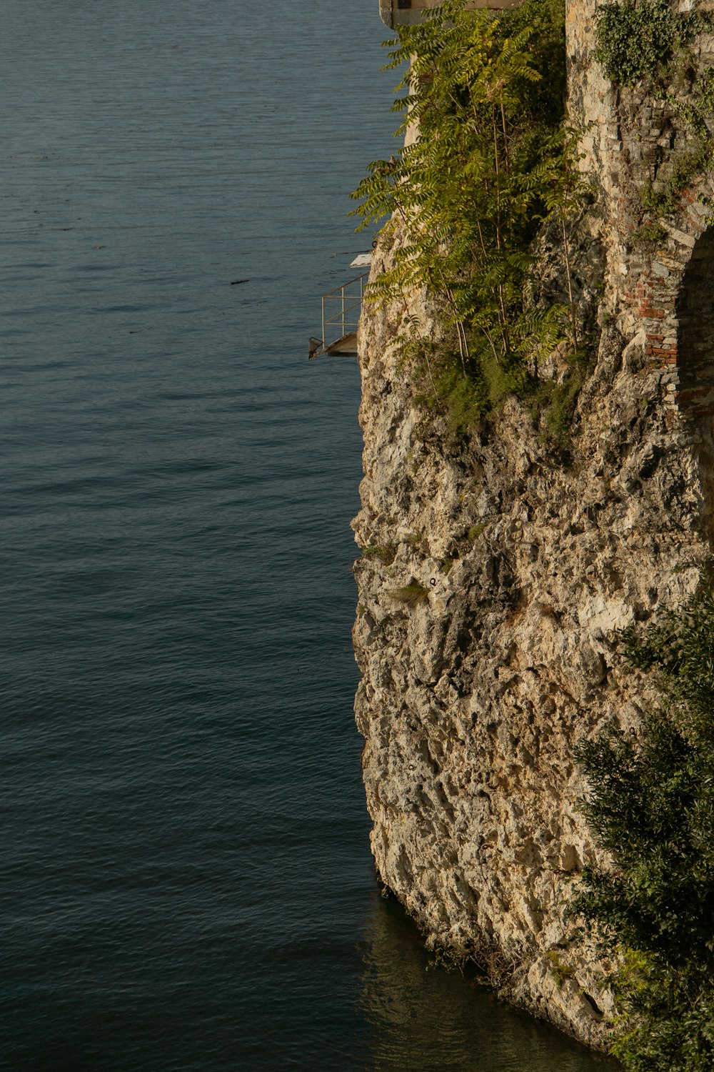 a cliff with a house on top of it