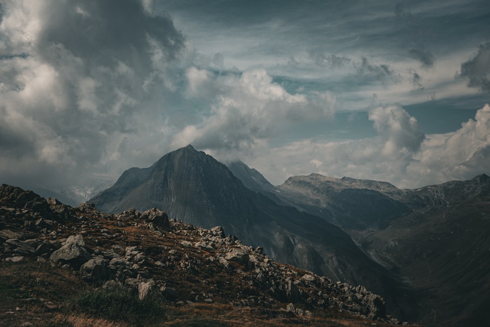 a view of a mountain range with clouds in the sky