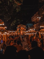 A cultural celebration with music, dance, and colorful decorations under evening lights.