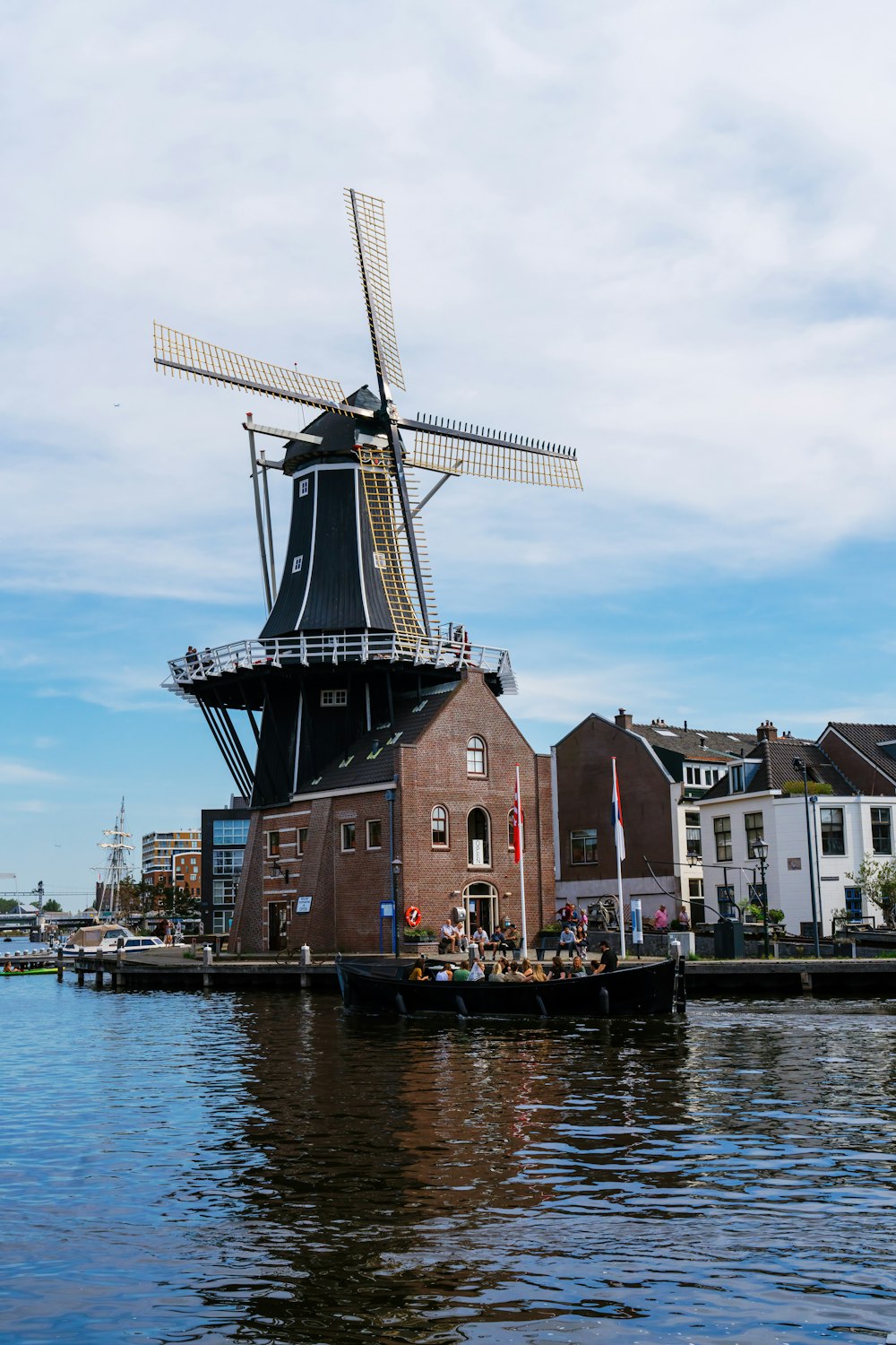 a windmill sitting on top of a body of water