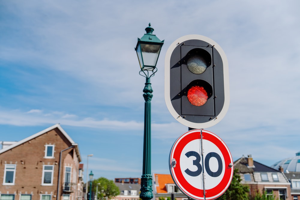 a traffic light sitting next to a street sign