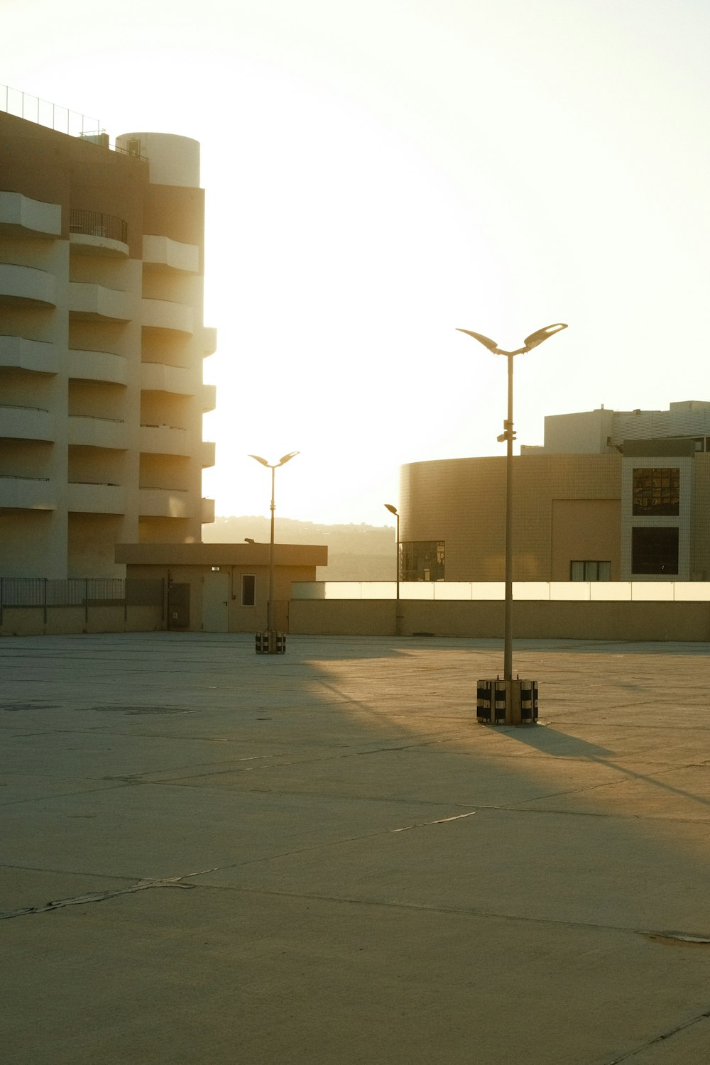 a parking lot with a building in the background