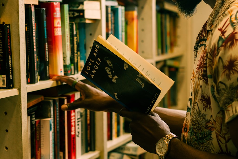 a man is reading a book in a library