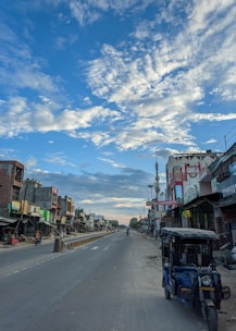 Wide shot of a quiet road beside empty plots in Jaipur