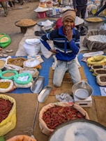 A smiling vendor handing a package to a happy customer at daund bazaar.