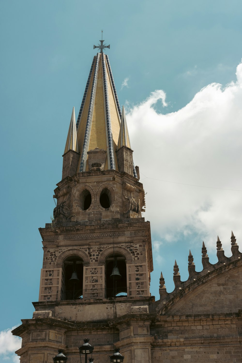 a tall tower with a cross on top of it