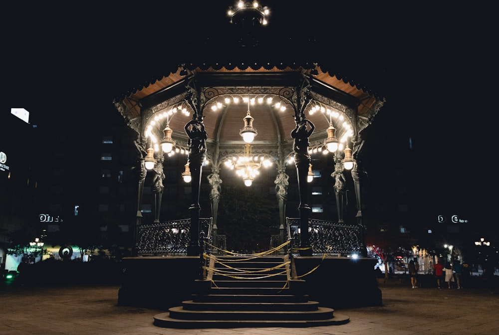 a lit up gazebo in the middle of the night