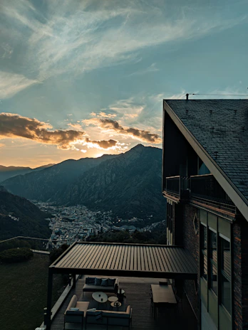 Sunset view over the resort’s outdoor seating area with mountain backdrop.