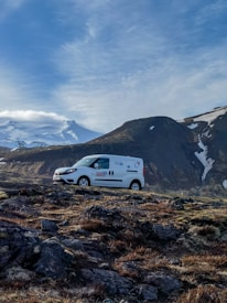 Mobile service van with rnd studio branding parked outside a business.