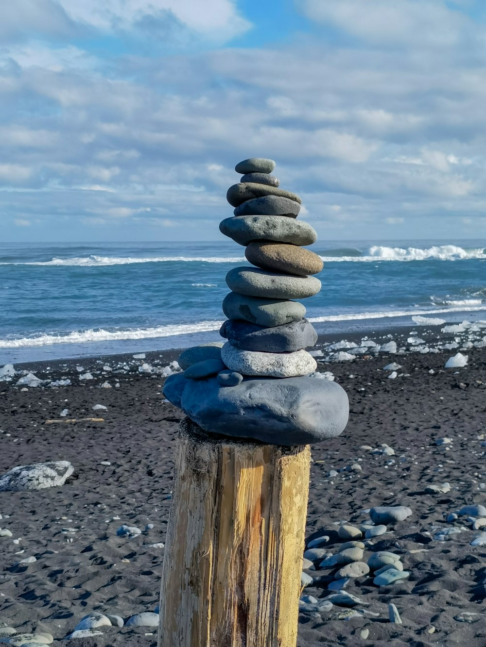 a pile of rocks sitting on top of a wooden post