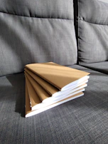 Stack of repaired notebooks ready for delivery to clients.