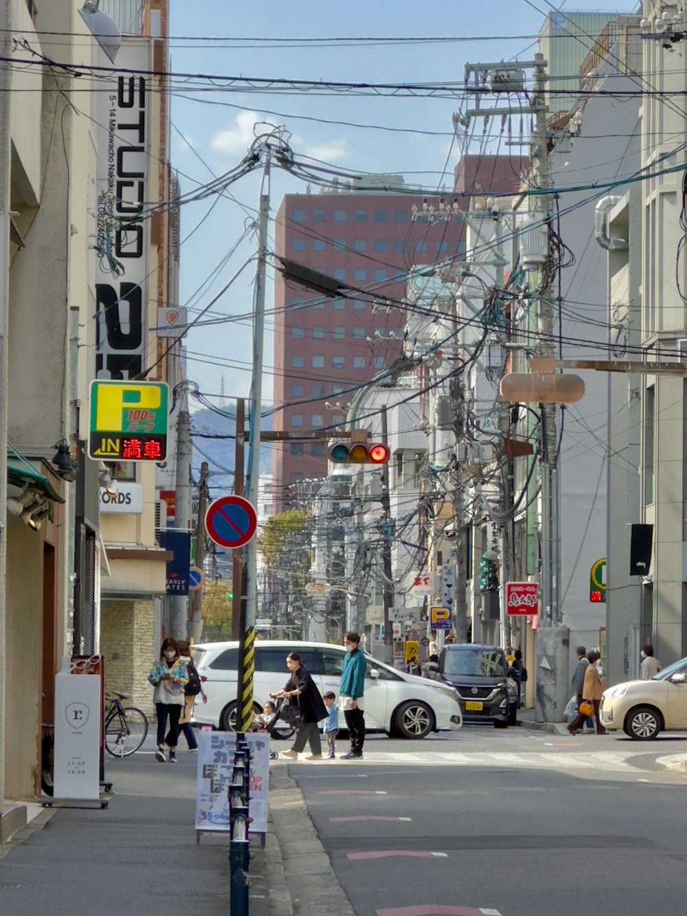 a city street filled with lots of traffic next to tall buildings