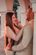 A warm, elegant photo of a Slavic woman and Middle Eastern man sharing a joyful moment in a softly lit, romantic setting.