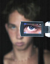 Close-up of a sharp shooter’s focused eye, reflecting determination within a digital matrix background.